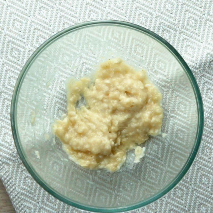 A glass bowl with mashed bananas.