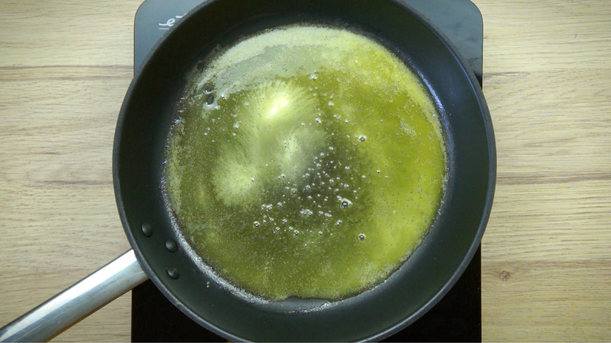 Frying pan with melted butter.