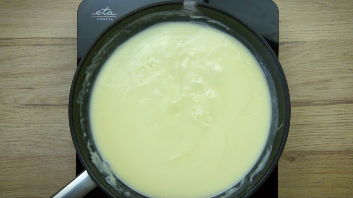 Frying pan with light yellow sauce.