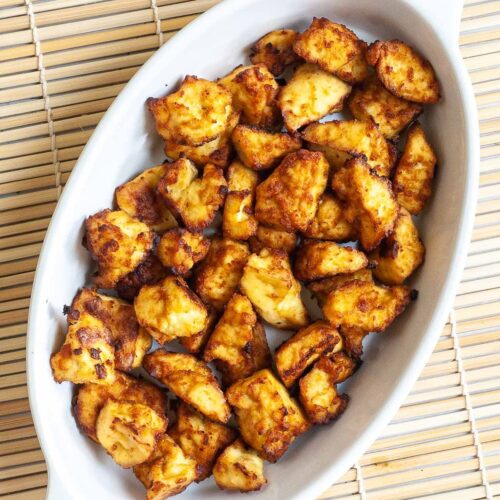 White bowl with yellow-brown tofu bites