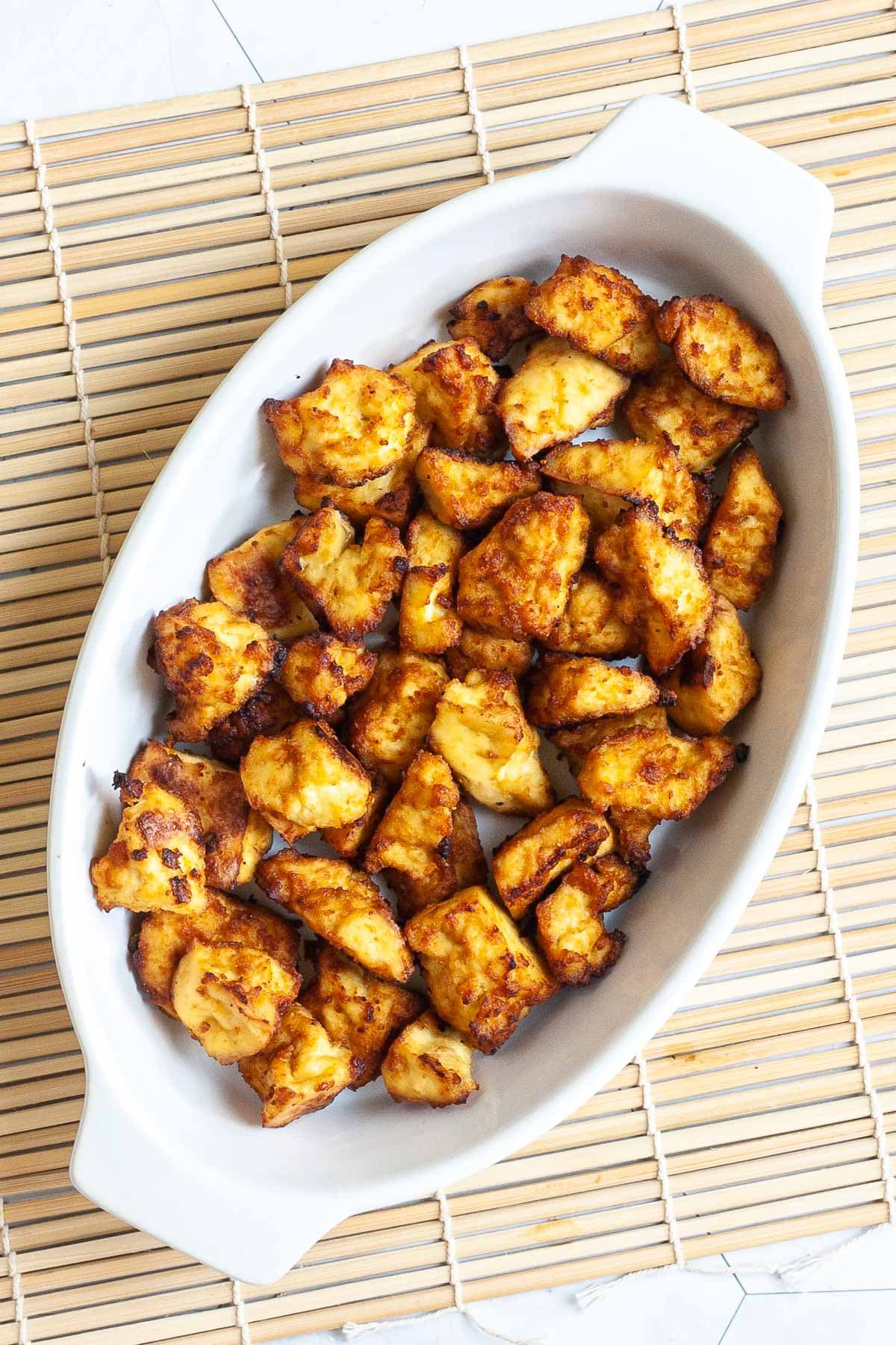 White bowl with yellow-brown tofu bites