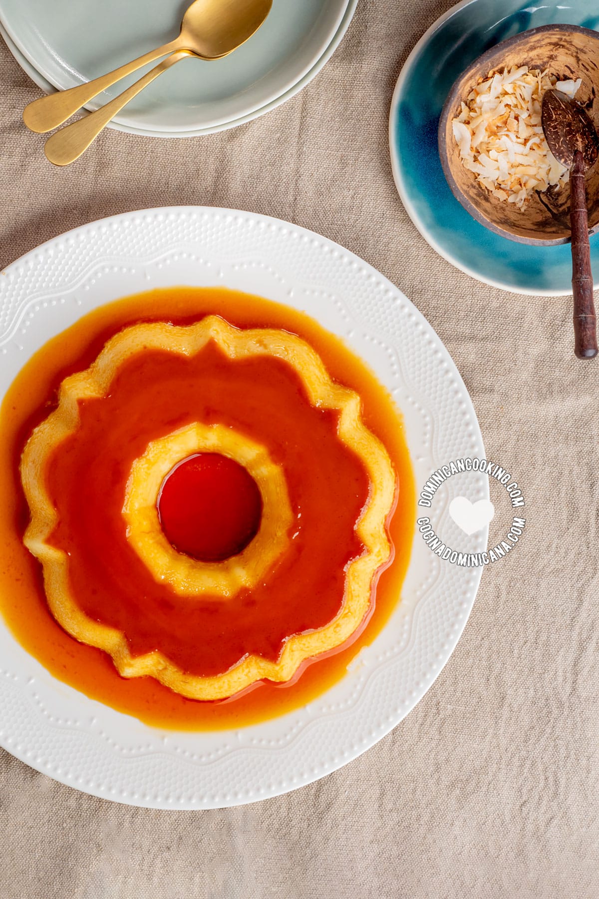 White serving plate with coconut flan on it.