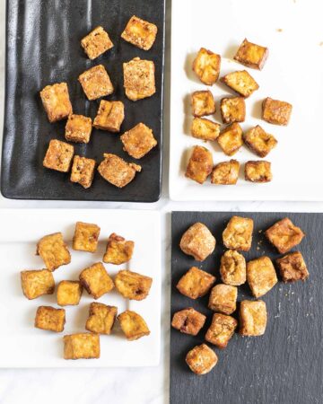 Crispy brown tofu cubes on 4 different plates of white and black.