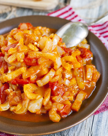 Red and yellow veggie stripes on a brown plate.