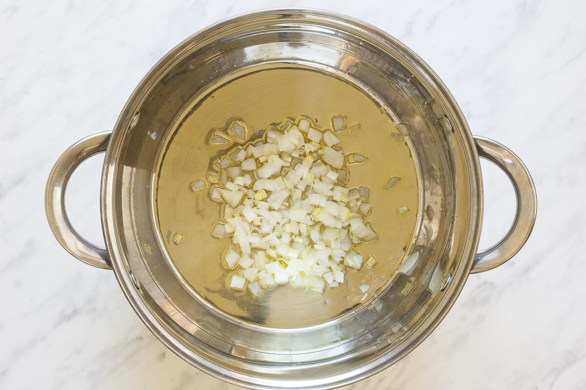 Stockpot with minced onion and garlic