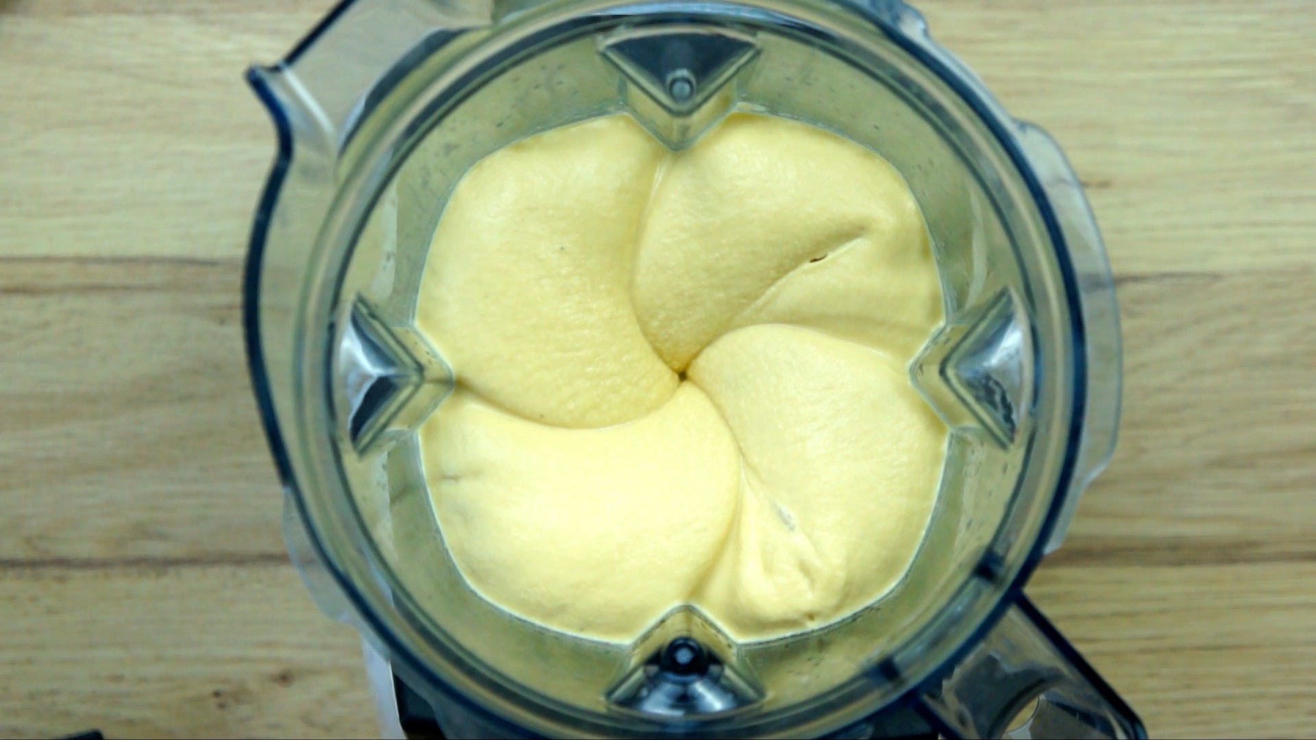 Blender with a smooth light brown hummus