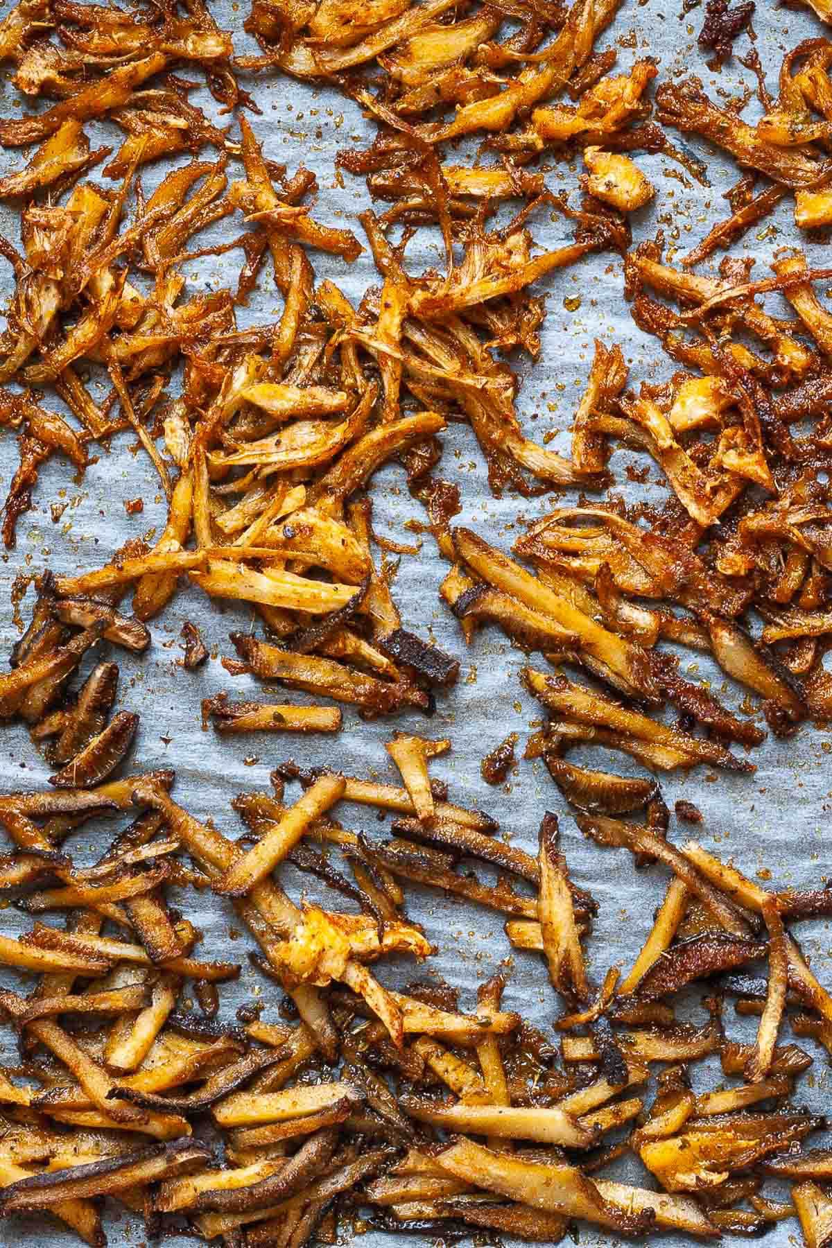 A parchment paper with crispy brown shredded king oyster mushroom