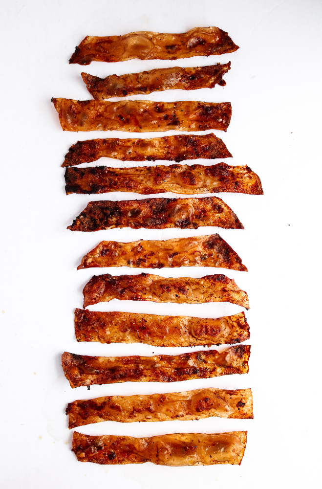 Crispy brown rice paper bacon strips covered in red spices