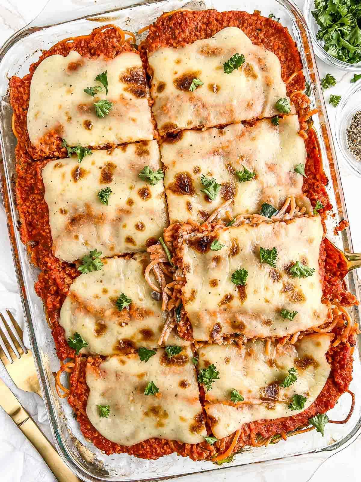 Casserole dish full of sliced baked spaghetti.