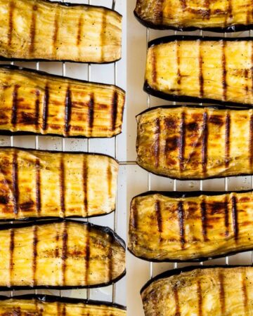 Roasted eggplant slices on a grill rack