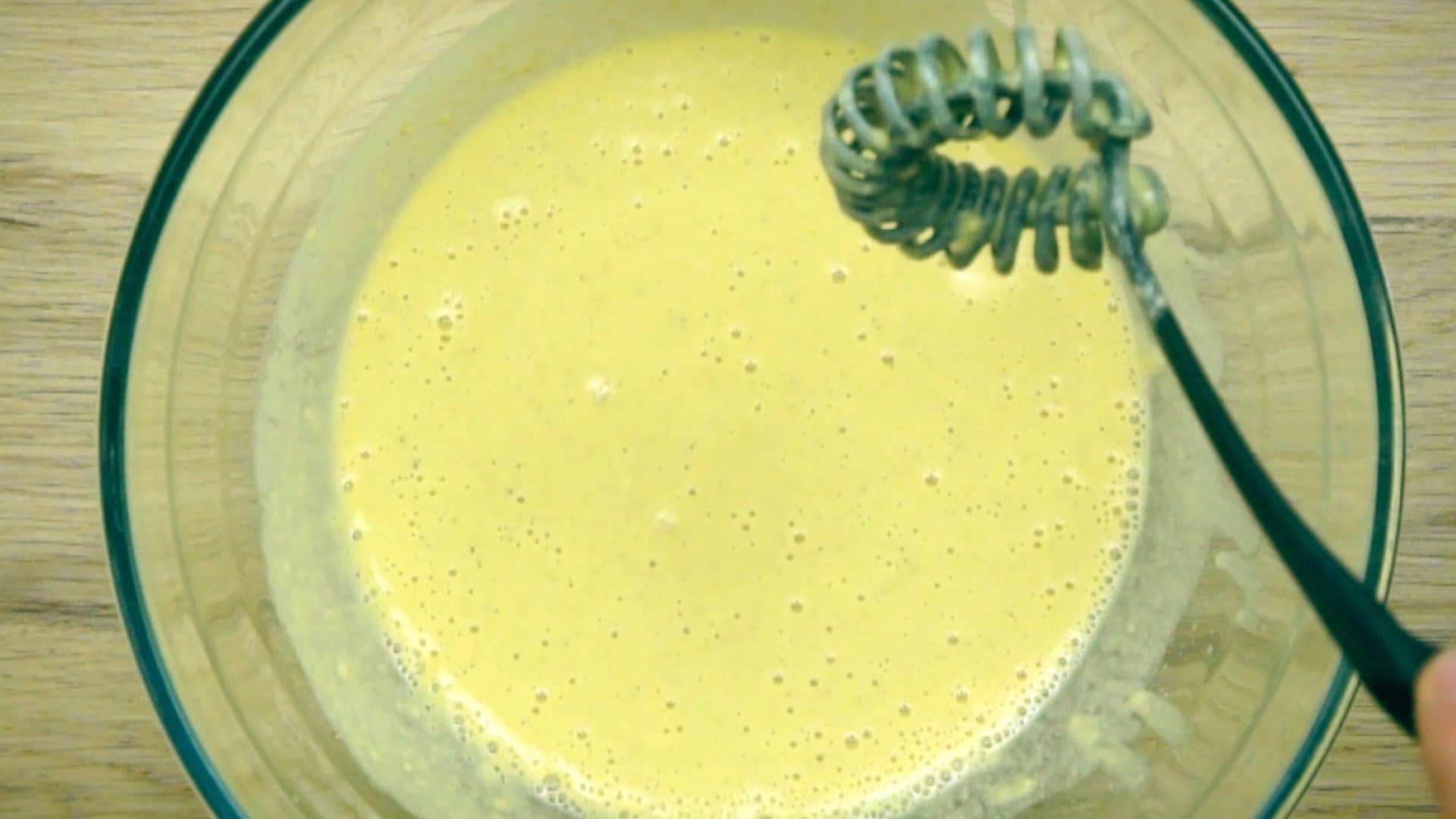 Yellow batter in a glass bowl.