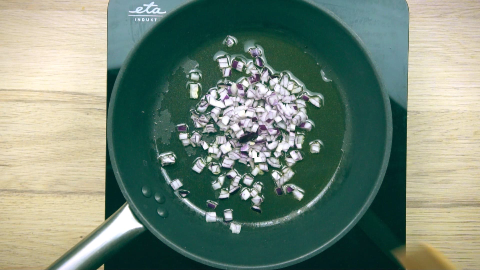 Frying pan with chopped onion.