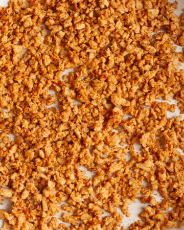 White frying pan with dark brown crumbles that reminds you of ground beef