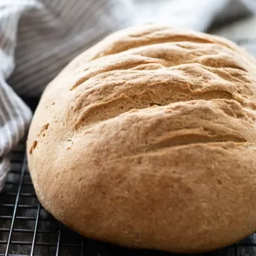 Nice crusty loaf of bread on a cooling rack