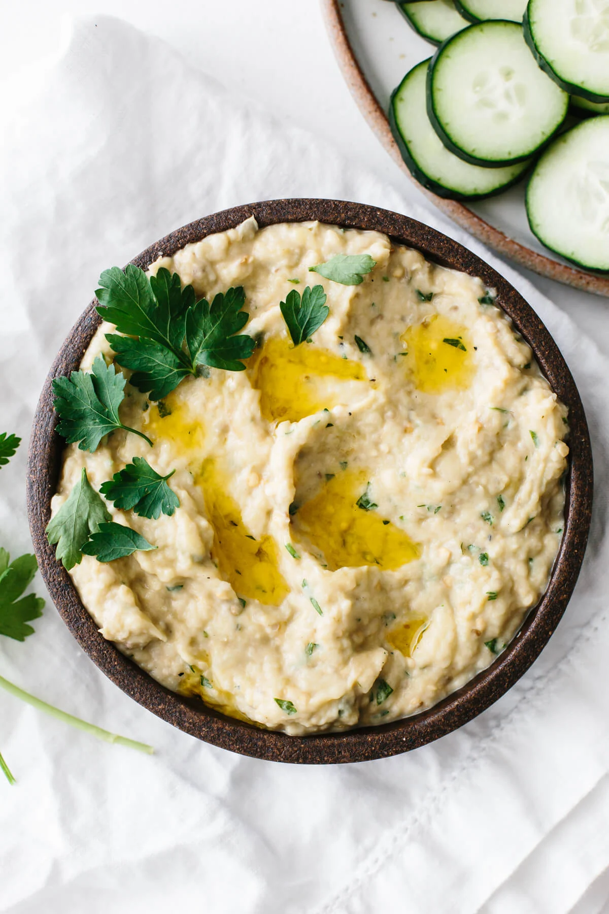 Baba ganoush in a bowl with garnish. / Baba ganoush is a delicious dip recipe made from roasted eggplants!