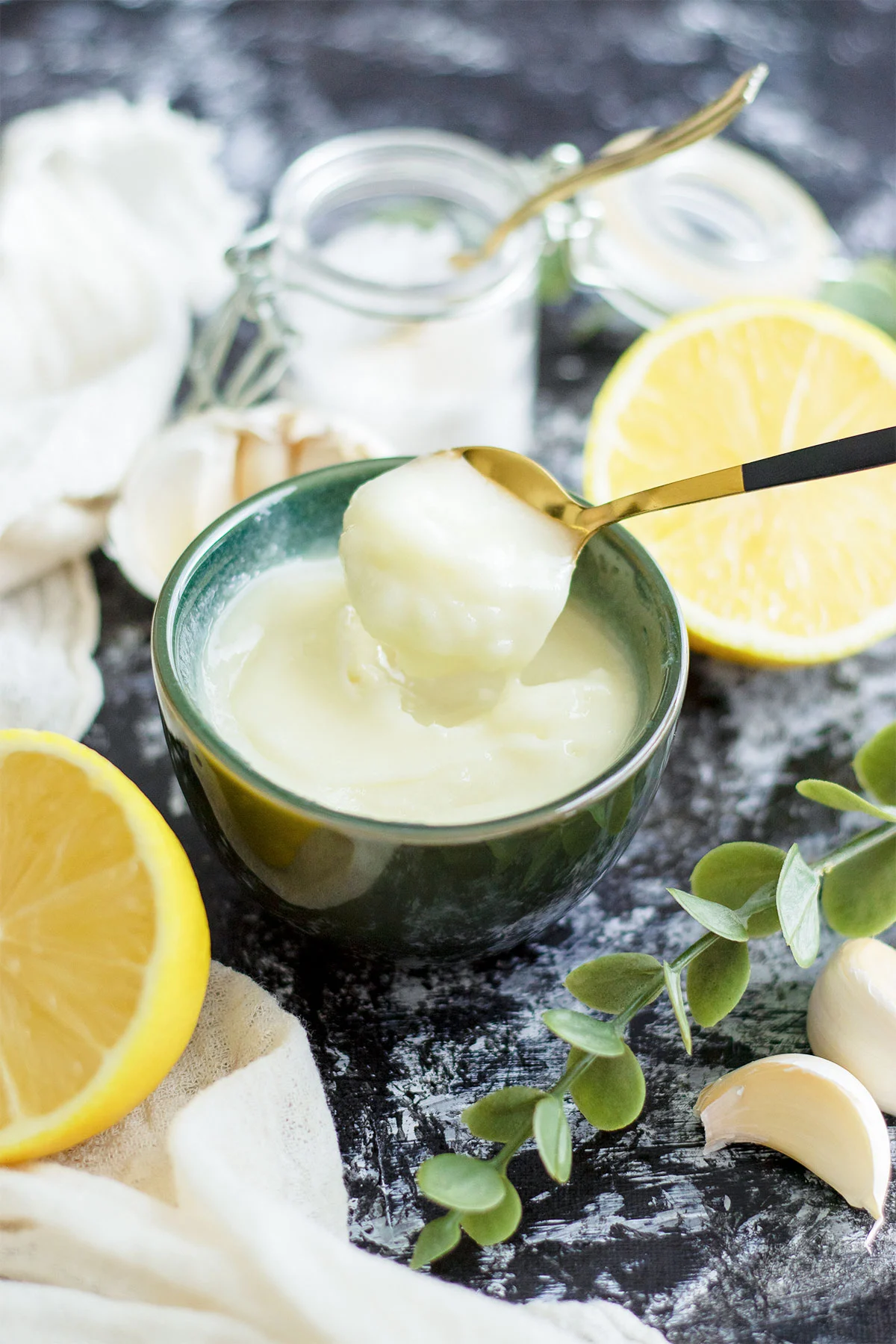 A bowl of Lebanese garlic sauce (toum) with a spoon.